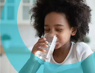 Little girl drinking a glass of water